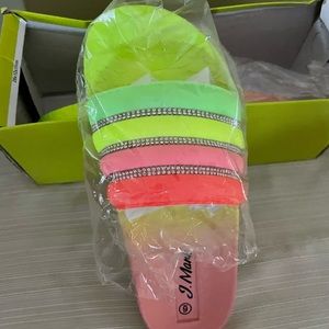 A pair of padded beach platform slide sandals